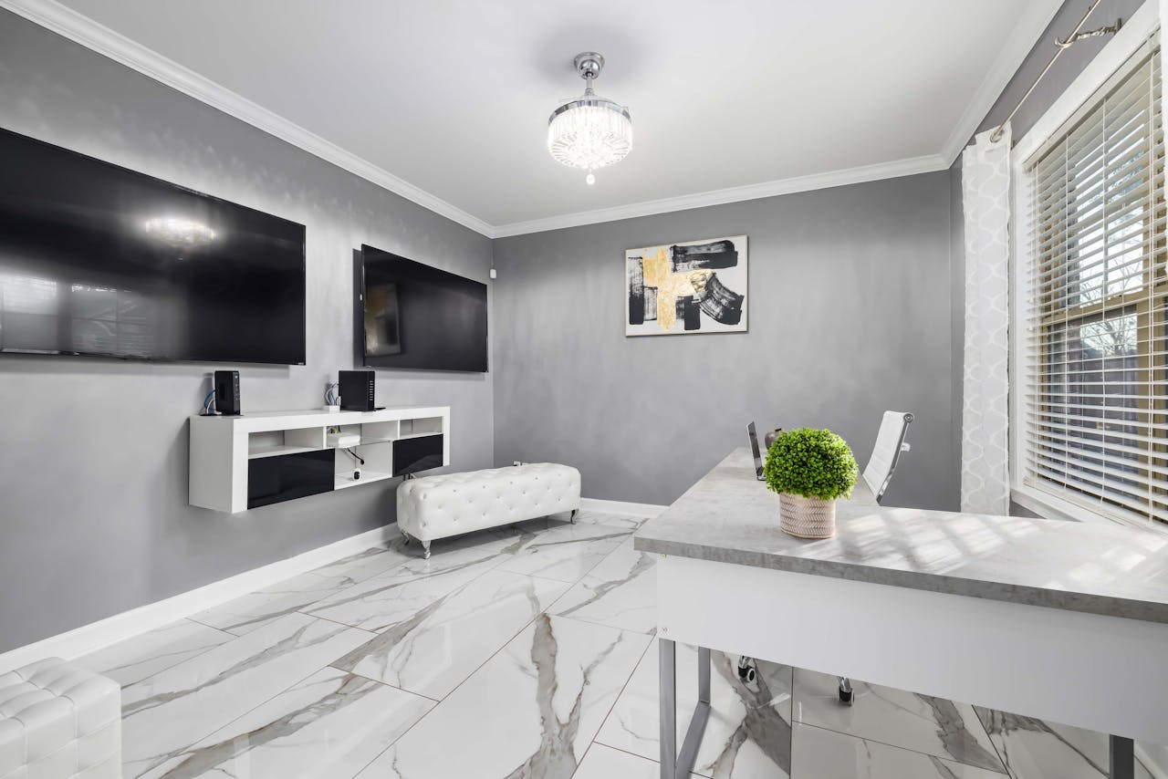 Stylish living room featuring dual wall-mounted televisions and elegant decor.